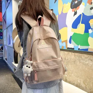 Stylish pink holographic backpack for student school and daily casual commute with cute plush pendant.