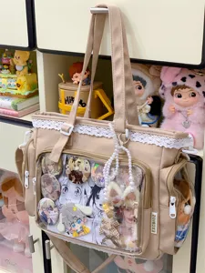 Japanese lace transparent ita-bag detail, beige shoulder bag with cute anime badges and plush accessories.