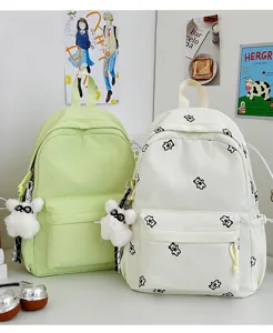 Cute bear print canvas backpack detail, sweet pastel school bag with plush pendant for daily use.