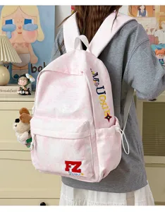 Pink tie-dye canvas backpack featuring unique embroidery letters, cute puppy pendant, side pockets.