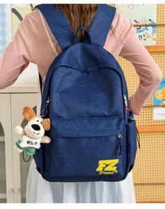 Vintage denim backpack for women and men, stylish school bag with a cute dog pendant and letters.