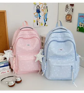Cute star print student school backpack detail scene, pastel pink and blue with sweet star pendants.