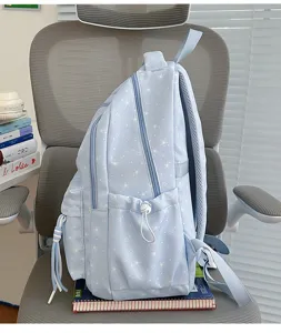 Light blue star print school backpack with multi compartments and side pockets for students.