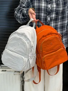 Lightweight nylon casual backpack for daily commute and travel. Dual color school bag detail.