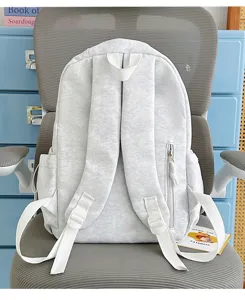 Grey vintage style backpack with white straps, casual lightweight daypack for school travel.