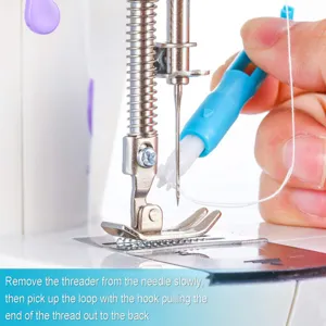 Detailed view of automatic sewing machine threader tool in action showing needle and presser foot