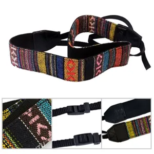 Vintage ethnic style woven camera strap details, showing texture, buckles and leather ends.