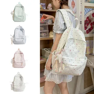 Cute Japanese style polka dot backpack with bow and star pendant, perfect for daily school use.