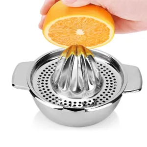 Stainless steel manual citrus squeezer detail, showing fruit juicing action and filter basket.