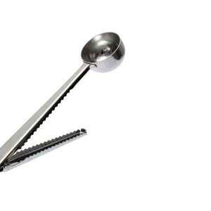 Stainless steel coffee measuring spoon with clip detail shot, perfect for kitchen use.