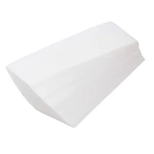 Close-up detail of white non-woven hair removal waxing paper strips, neatly stacked texture.