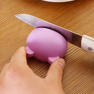 Mini cartoon knife sharpener portable kitchen tool for quick blade sharpening pink design.