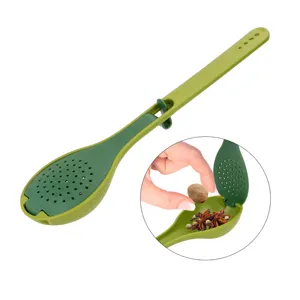 Close-up detail of green plastic spice spoon strainer with fine mesh filter and secure locking clip.