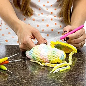 Soft handle crochet hook detail, ergonomic TPR grip and aluminum tip for smooth knitting crafts.