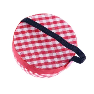 Red white gingham wrist pincushion detail shot, portable DIY sewing tool accessory.