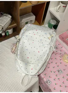 Cute Japanese style white backpack with polka dots, pink hearts, and blue bows for daily use.
