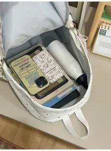 Detailed view of the cute Japanese style polka dot backpack interior capacity display.