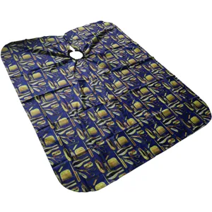 Detailed close-up view of the adult barber cape featuring classic hairdressing tool patterns.