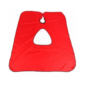 Haircut cape detail showing transparent viewing window and soft red pongee fabric material.