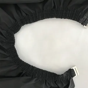 Close-up detail of black pongee phone viewing cape elastic neck and buckle fastener.