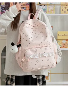 Zaino rosa in tela per ragazze con stampa di stelle, tasca con volant e grazioso ciondolo cucciolo.