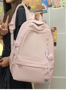 Minimalist pink backpack for women and men, large capacity travel school bag for students daily use.