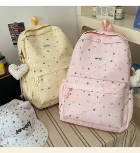 Detailed close-up of sweet style star printed school backpacks in soft yellow and pink.