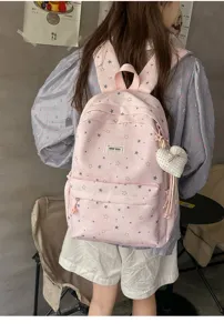 Pink star pattern backpack detail view, casual Japanese style school bag with heart pendant.