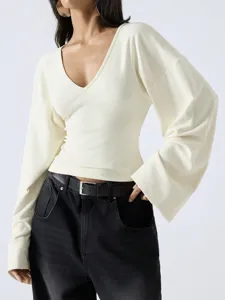 Elegant V-neck long sleeve top with flared cuffs and relaxed drop shoulder design.