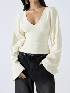 Detailed view of the cream V-neck top featuring dropped shoulders and trendy flare sleeves.