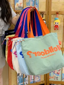 Canvas tote bag with drawstring closure, colorblock design, casual daily shoulder bag.