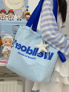 Detail shot of Korean dopamine canvas tote bag in light blue, large capacity with star pendant.