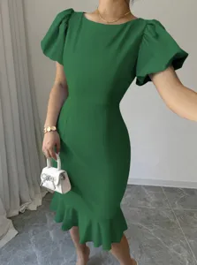 Elegant green puff sleeve dress detail, featuring slim fit mermaid hem and refined tailoring.