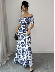 Close-up detail shot of the blue and white floral off-shoulder cutout maxi dress set.