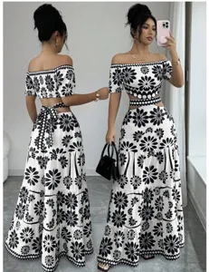 Black and white floral two piece set detail featuring off shoulder crop top and maxi skirt.