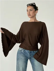 Detailed view of the brown boat neck flare sleeve top featuring elegant long dramatic sleeves.