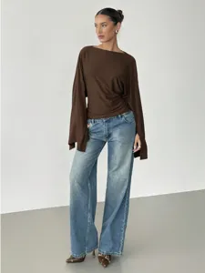 Women stylish long sleeve casual top detail view with blue wide leg denim jeans fashion.