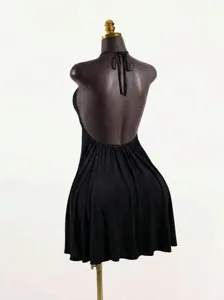Close-up view of the black halter backless top, showing the elegant tie and drape detail.