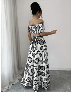 Black and white floral off-shoulder crop top and high-waist cutout tie maxi skirt set.