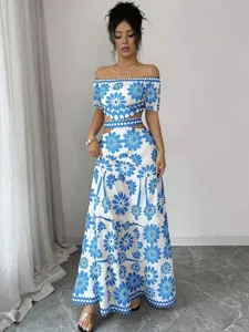 Detailed view of blue and white floral off shoulder crop top and tiered maxi skirt set.