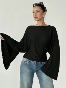Close-up view of the elegant black long bell sleeve blouse, highlighting the stylish boat neckline.