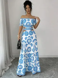 Blue and white floral off-the-shoulder crop top and high waist cutout maxi skirt set detail.