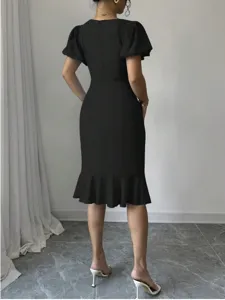Elegant black puff sleeve midi dress with fishtail hem, slim fit bodycon design for women.