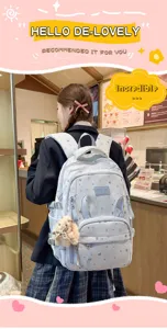 Zaino scolastico carino con motivo a stelle, orecchie di coniglio e ciondolo in peluche.