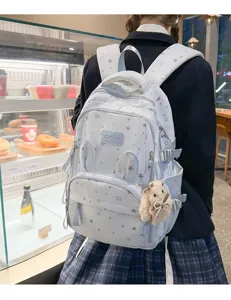 Zaino scolastico carino con stampa a stelle, orecchie di coniglio e ciondolo in peluche.