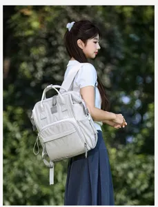 Detail view of the stylish large capacity grey mom backpack with convenient multi-pocket design.