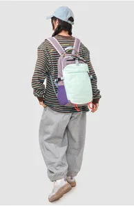 Detail view of the colorful patchwork patchwork backpack showing top handle and front pocket design.