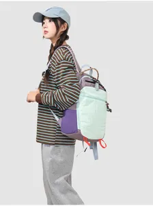 Side detail view of the minimalist color-block backpack, showcasing outdoor style and pockets.