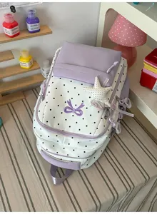 Zaino scolastico con pois, fiocco e ciondolo a stella, un elegante zaino casual per ragazze.