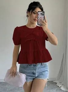 Women short sleeve solid color bow tie blouse casual summer top paired with denim shorts.
